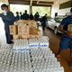 Firefighters and recruits for the Jackson, Miss., Fire Department carry cases of bottled water to residents vehicles, Aug. 18, 2022, as part of the city’s response to longstanding water system problems.
